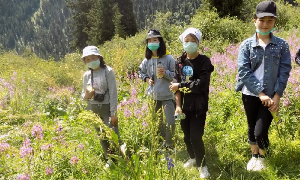 Three children assisting an eco camp